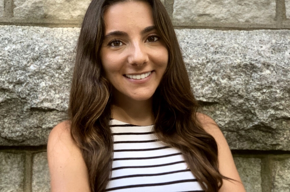 Headshot of Marta Llor with stone wall background