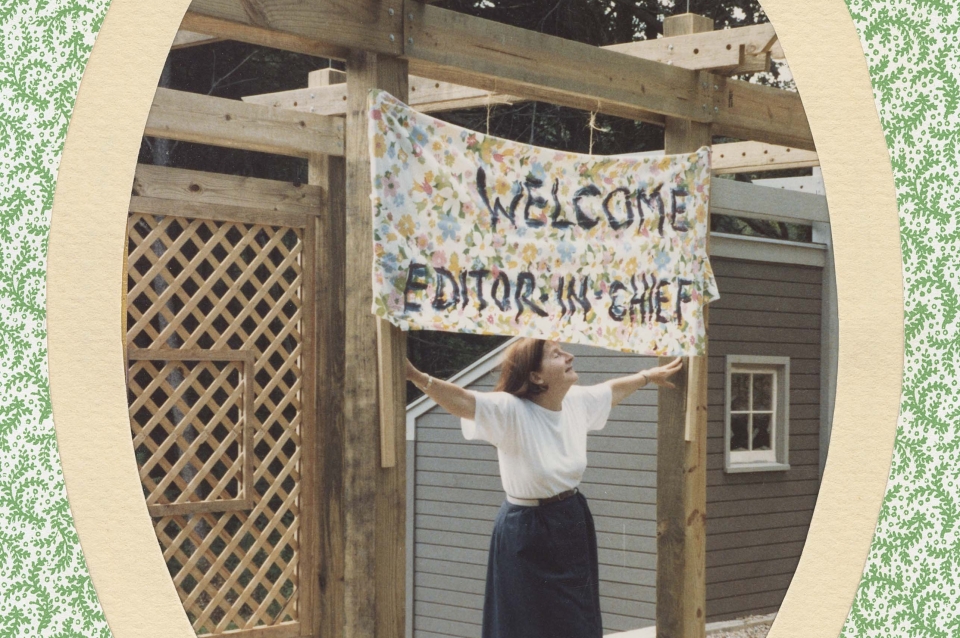 Woman holding sign saying "Welcome editor in chief"