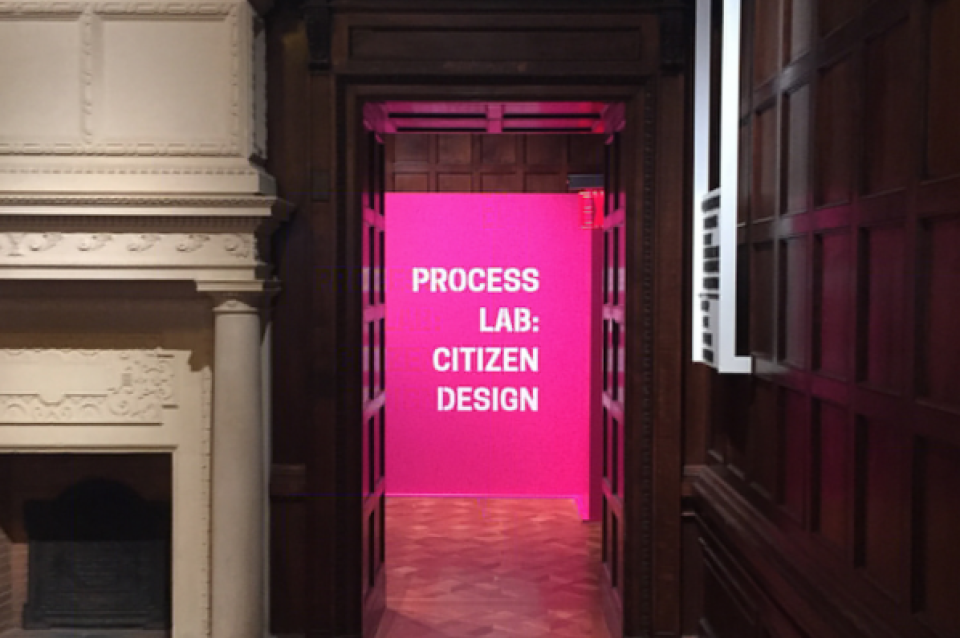 Baroque room with doorway leading to pink neon room with sign saying "Process Lab: Citizen Design"