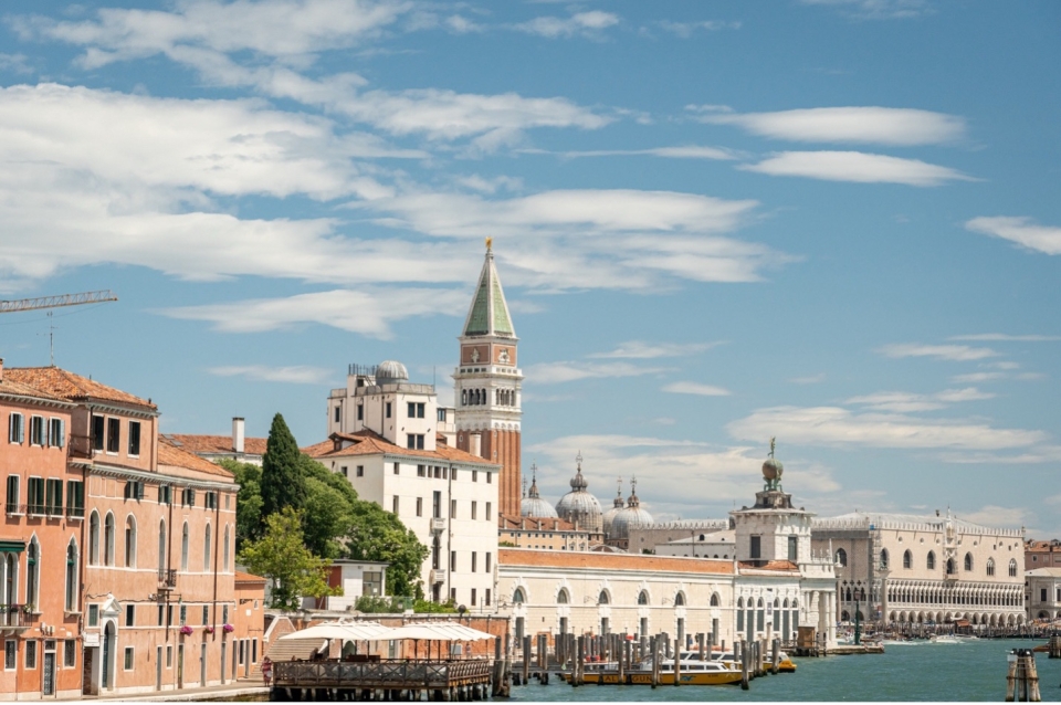 Venitian Gothic buildings including bell tower under blue sky