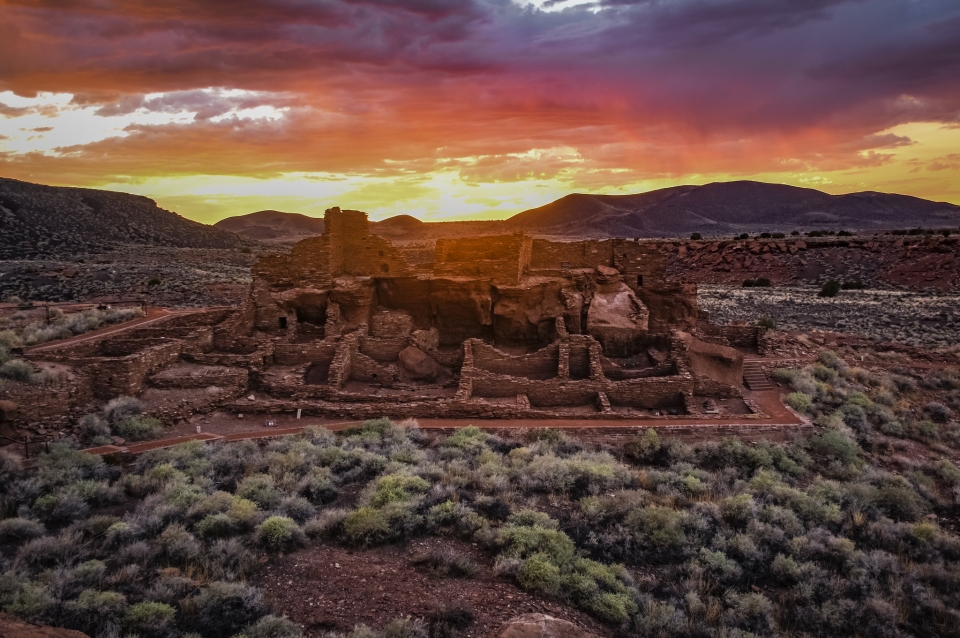 Adobe structure in partial ruin in the desert at dusk
