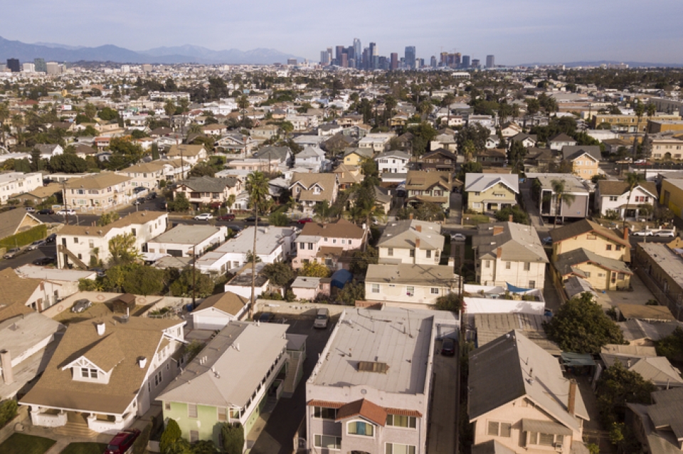 Birds eye view of houses with Philadelphia skyline far off in the distance
