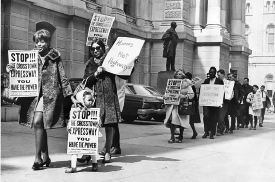 B/W photo of protestors outside of city hall protesting expressway