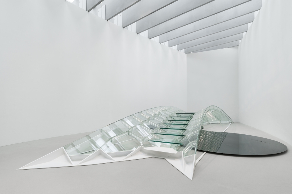 Crystalline glass span reflected in mirrored floor piece in art gallery