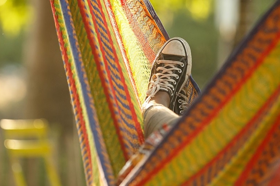Hammock with person in it but only their foot is visible.