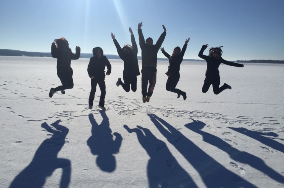 Group in Desert Jumping Up in Air
