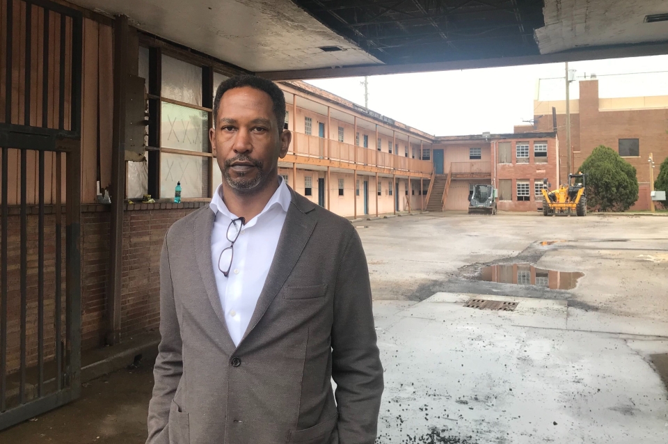 A headshot of Brent Leggs underneath an old building. 