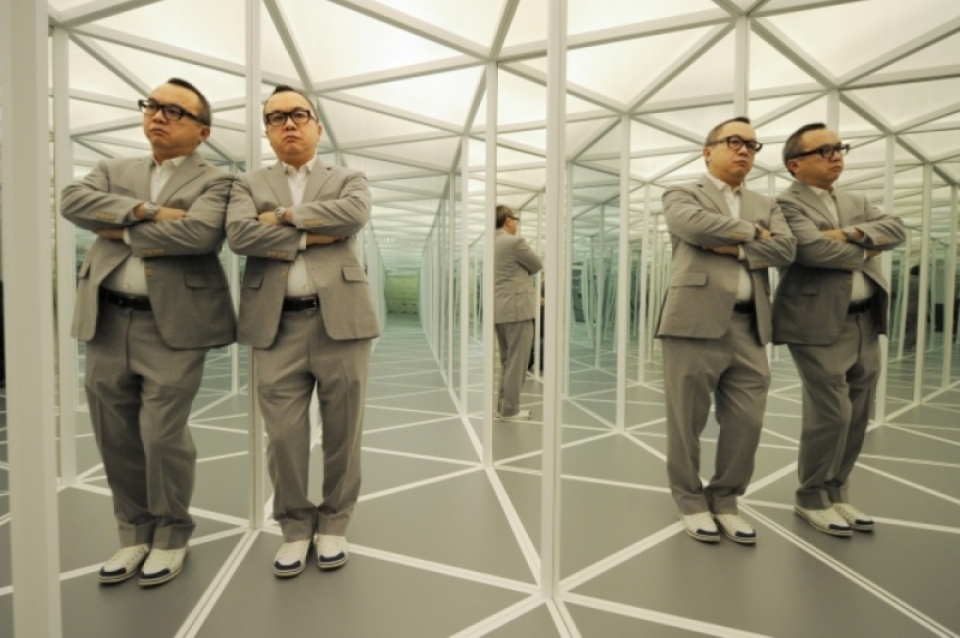 Ken Lum posing in hall of mirrors