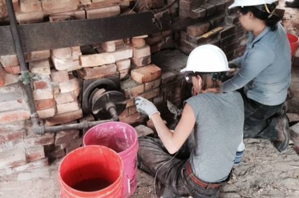 Casey Weisdock (left) and Jean Jang (right) have been putting in many hours with trowel in hand in the effort to stop deterioration at Kilns 7 and 8.