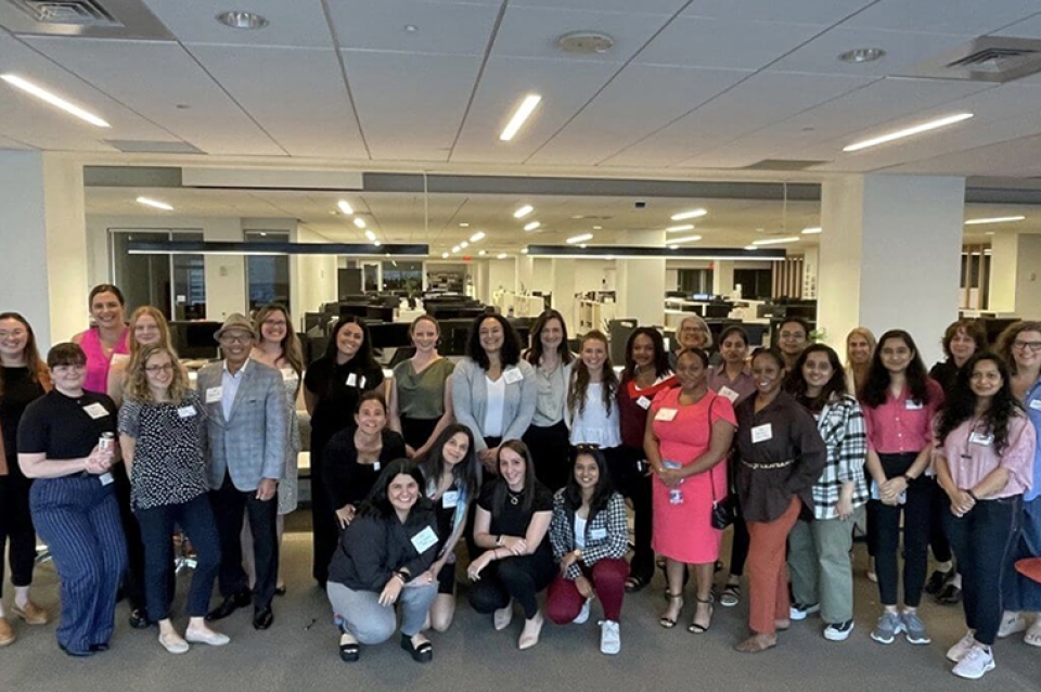 Group picture featuring attendees at a PWC event.