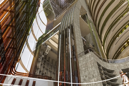 Ringed towers in brick and glass ascend overhead