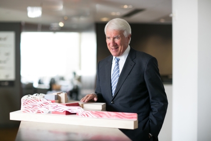 Gene Kohn stands with a table model