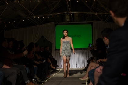 Runway model wearing dress designed by Caroline Morgan