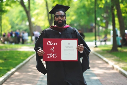 Student holding up diploma
