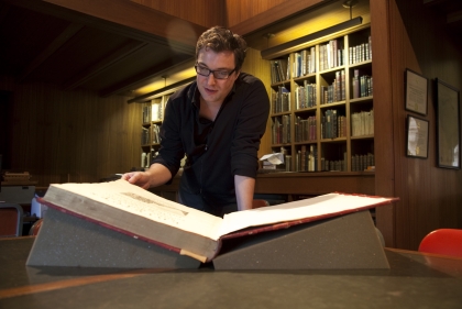 Man reading enormous book
