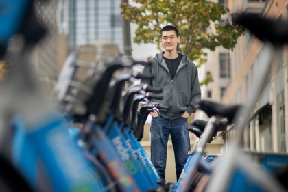 Dong standing behind a row of parked bikes