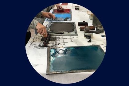 Inked printing screens laid out on a table 