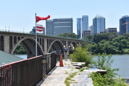 waterway with bridge and city in the background, featuring Washington DC flag