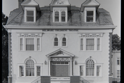 White 3-story facade with sign "Delaware Childrens Theatre" in B&W photograph