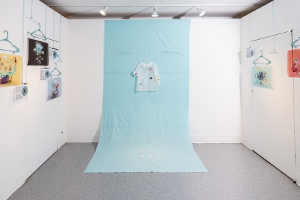 Installation of a design project with a long blue cloth and dress form