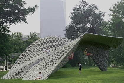 A person sits atop a gray lattice structure shaped like bandshell that has been crumpled on one end. Two other people climb.