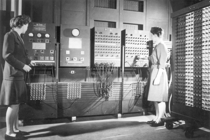 Black and white image of the ENIAC and two women "computers"