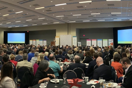 Lisa Servon at the podium in a ballroom with conference attendees