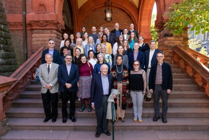 group photo outdoors on entry steps of red brick building