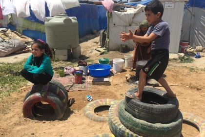 Children playing on some tires in Lebanon