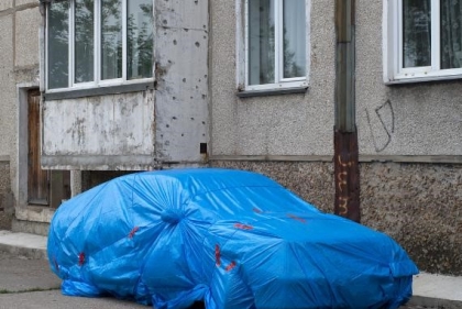 Car wrapped in tarp