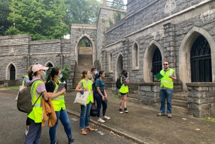 Group of people in yellow vests at cemetery