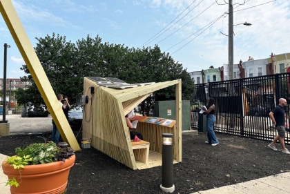 Wooden pavilion with books inside on a sunny day