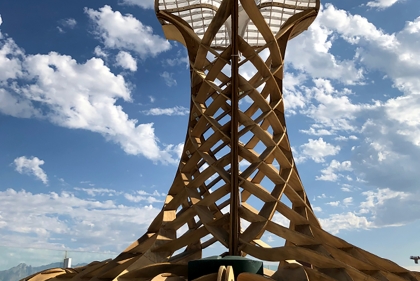 Plywood frame construction of chimney structure with sky in the background and membrane on the top funnel