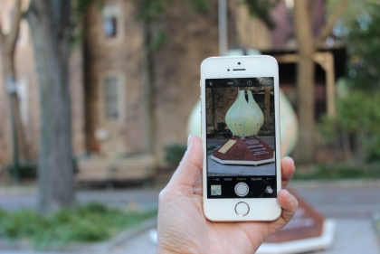 Person taking picture of the BLOSSOM sculpture