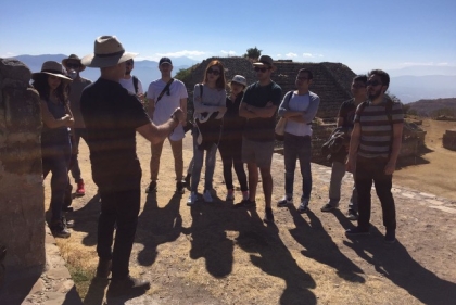 Students gathered and listening to instructor