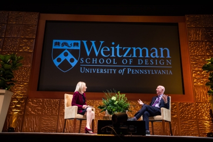 Dr Amy Gutmann seated on stage across from Paul Goldberger