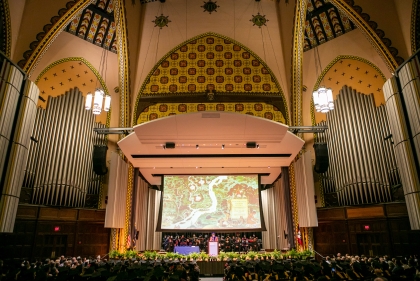 Ornate murals and organ pipes flank a proscenium stage