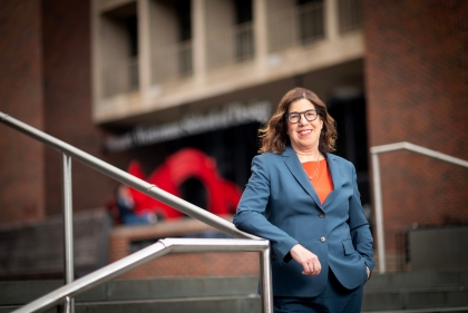 Leslie Richards in front of red brick building