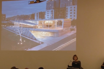 Woman giving presentation with projection in the background