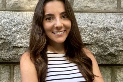 Headshot of Marta Llor with stone wall background