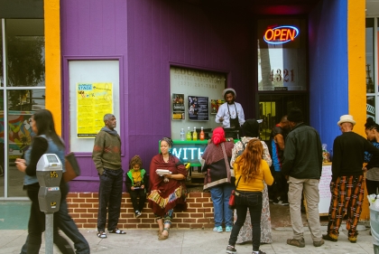 Urban storefront area with pedestrians hanging out