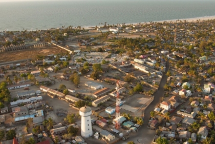 birdseye view of low-rise buildings with ocean in distance  