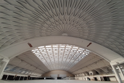 Large arched white dome building with ornamental ceiling