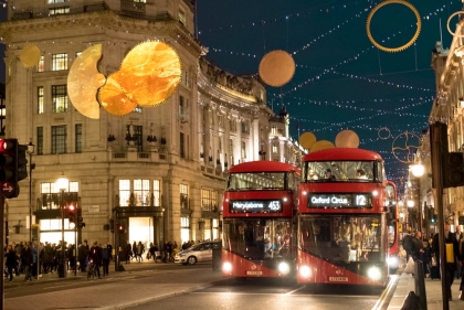 London busses under decorations at night