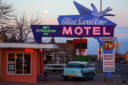 Twilight view of the neon-lit Blue Swallow Hotel along Route 66 in Tucumcari, New Mexico