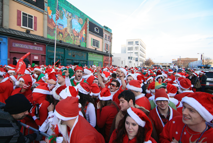 "Running of the Santas" participants running in Santa outfits
