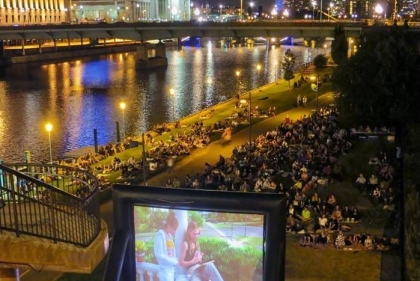 Movie being projected on Schuylkill with crowd watching