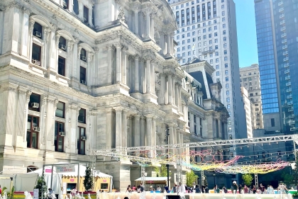 City fountain and roller skating in front of City Hall on a sunny day.