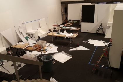 Vacant design studio with paper project strewn all around the desks
