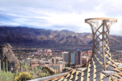 Lattice tower stands over a desert cityscape